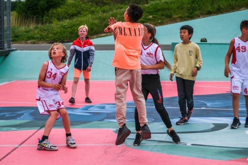 Afbeelding: foto met kinderen basketballen op het DreamCourt. Foto: Blue-sky fotografie.
